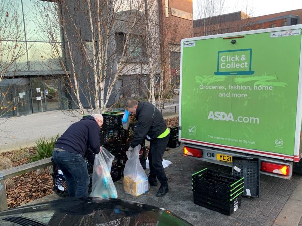 Asda driver Warren helping Senior Firmware Engineer
 Julian pack food donations