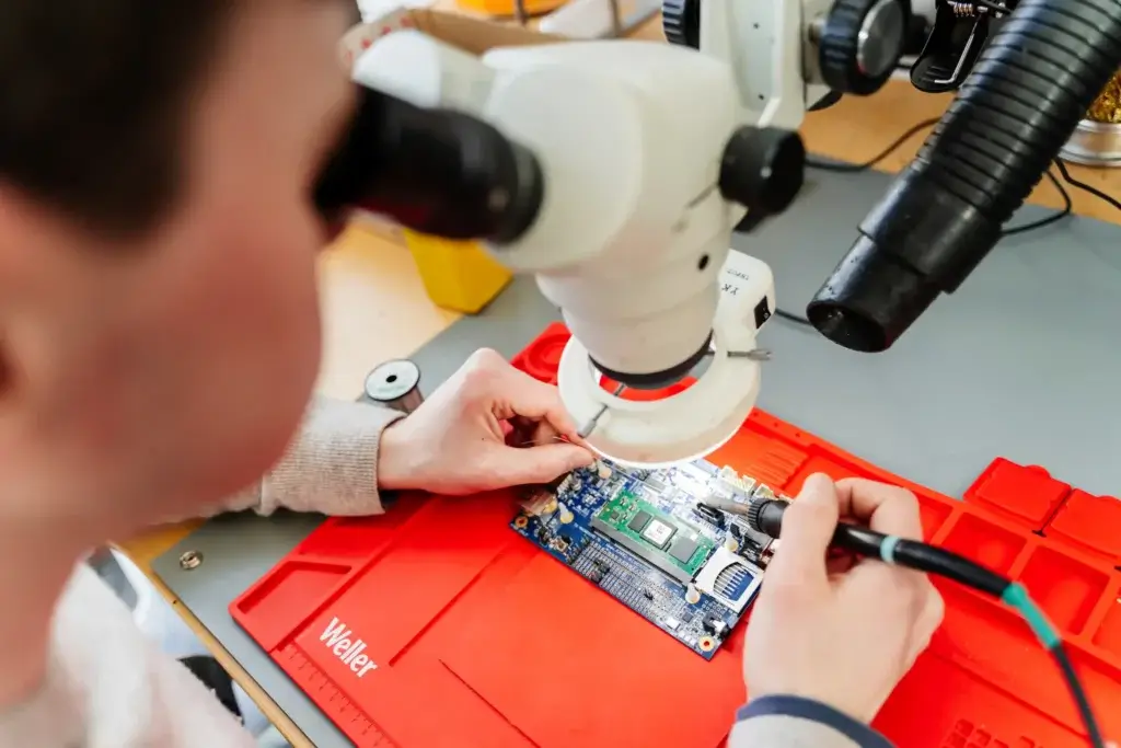 Custom PCB design - hardware engineer working at the soldering station at ByteSnap